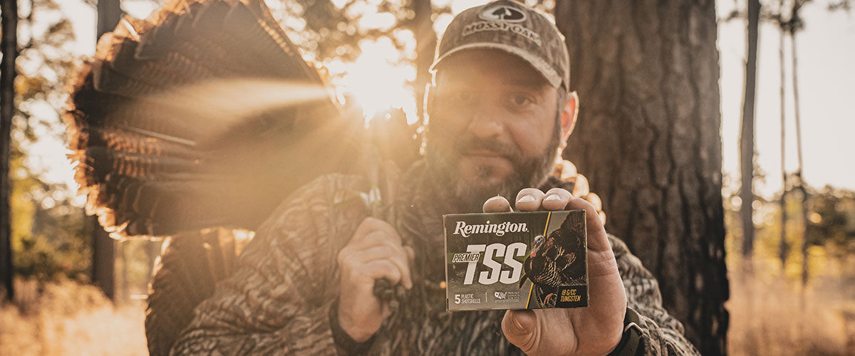 hunter holding turkey and box of Premier TSS