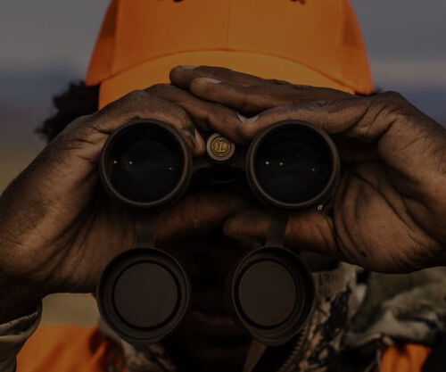 hunter looking through binoculars